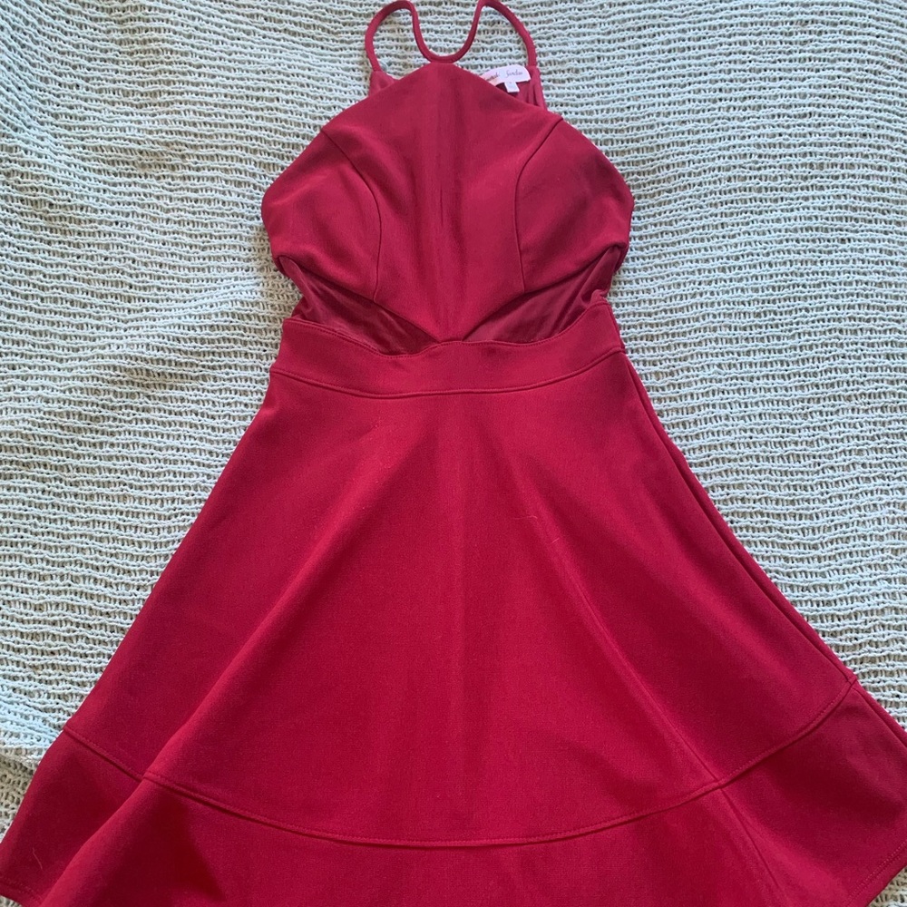 Red skater dress with mesh sides at the waist.